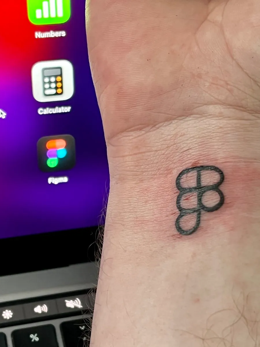 Three-ring Cleedek logo tattooed on a wrist